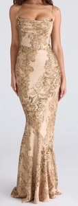 Close-up of champagne gold floral jacquard fabric on a bodycon elegant maxi dress