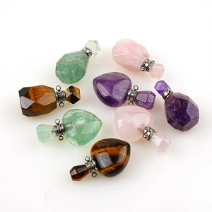 Detailed overhead view of natural gemstone perfume bottle pendants in heart and geometric shapes