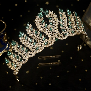 Luxurious vintage bridal crown with green crystals and gold leaf feather design