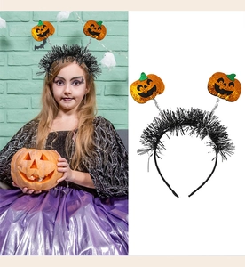 Detail of Halloween headband with orange sequined pumpkins on springs and black plush band