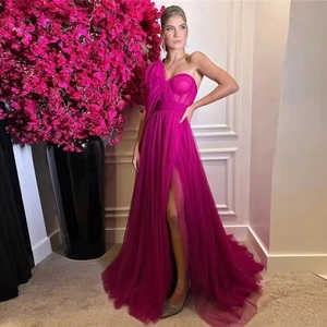 Detail of fuchsia corset evening gown with mesh draping and high leg slit feature