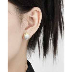 Minimalist S925 sterling silver stud earrings with irregular texture on female model