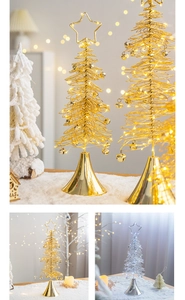Detail of metal wire Christmas tree with warm LED lights and bells for desk decor