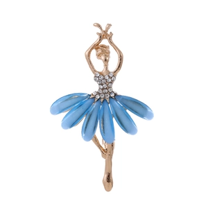 Detailed close-up of a golden ballerina brooch with blue resin petals and sparkling crystals