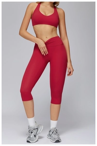 Detail view of red V-neck halter sports bra and high-waist cropped yoga leggings