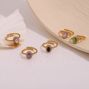 Detailed shot of adjustable gold rings with colorful oval gems and zircon halo stones