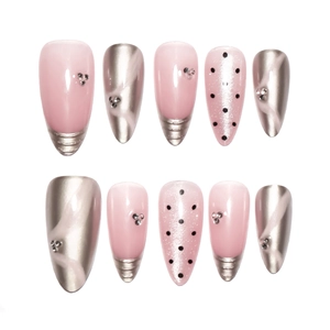 Pink cat eye press-on nails with silver chrome 3D accents and sparkling rhinestones