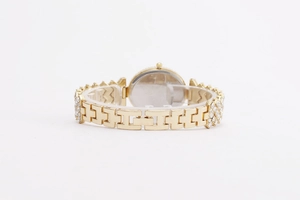 Detail view of gold metal watch strap with crystal inlay and folding clasp closure