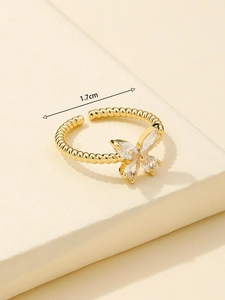 Detail of gold bow ring with teardrop zircons and 1.7cm inner diameter measurement