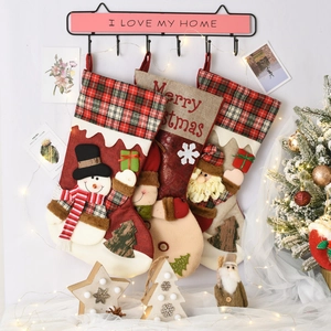 Detailed view of Christmas stockings with Santa and reindeer hanging on a wall
