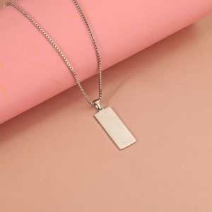 Close-up of a silver stainless steel rectangular bar pendant on a sturdy box chain necklace