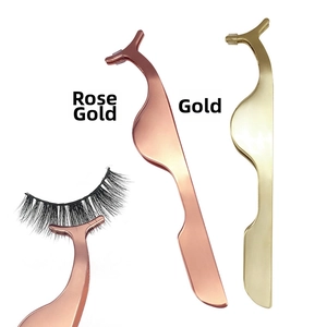 Macro view of rose gold and gold magnetic eyelash tweezers with ergonomic curved tips