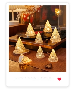 Detail of crystal Christmas tree night lights with geometric cuts on a vintage player