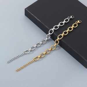 Detail of twisted cable oval link chain in gold and silver stainless steel with clasp