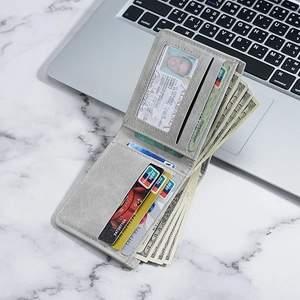 Slim grey matte wallet for men with multi-card slots and ID window on marble background