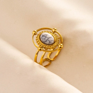 Macro detail of vintage celestial style gold ring with oval white turquoise stone