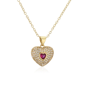 Gold plated heart necklace with red gem and micro paved zircons on white background