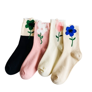 Floral cotton mid-calf socks for women featuring colorful knit flower patterns