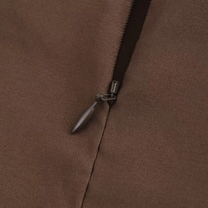 Detail of dark brown woven fabric featuring a matching teardrop invisible zipper closure
