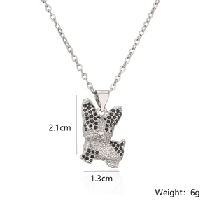 Silver puppy pendant necklace with clear zircons and size details on white background