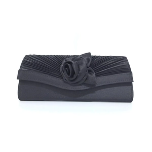 Elegant black satin evening clutch bag featuring a handmade 3D rose and pleated texture