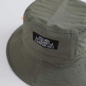 Dark green quick-dry bucket hat with nature logo patch and adjustable orange strap