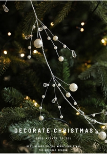 Detail of Christmas pearl bead string with crystal pendants on a decorated festive tree