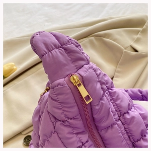 Detail of purple quilted cloud tote bag featuring high-quality gold metal zipper closure