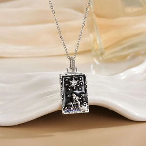 Detail of silver tarot card star pendant with black enamel and colored zircon stones
