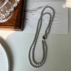 Detailed view of double-layer grey pearl necklace with vintage geometric metal clasp