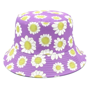 Close-up of purple bucket hat featuring vibrant white and yellow daisy floral patterns