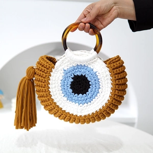 Handwoven beach bag in yellow, blue and white with round handles and fringe