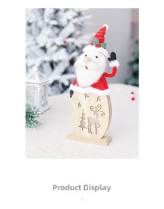 Close-up of lighted wooden Christmas decoration with hollowed reindeer and Santa plush