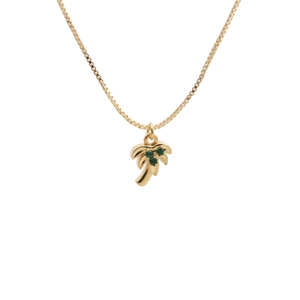 Macro detail of gold palm tree pendant with green zircon stones on fine box chain