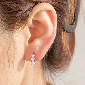 Silver heart zircon hoop earring for women with sparkling cubic zirconia on model