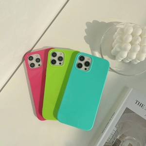 Close-up of three jelly-colored silicone iPhone cases in pink green and blue