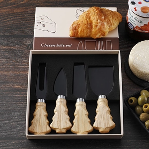Detailed view of 4-piece cheese knife set with Christmas tree wood handles in a gift box