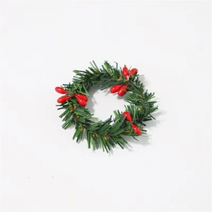 Miniature Christmas candle ring with green PVC pine needles and red berries on white base