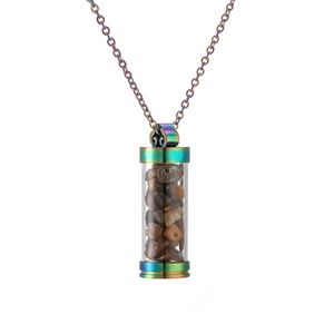 Macro shot of refillable perfume bottle pendant with brown stones and rainbow plating