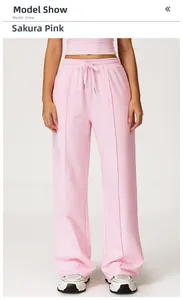 Detail view of cherry pink sweatpants with drawstring waist and stitched front crease