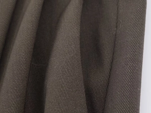 Close-up of premium brown twill blazer fabric showing detailed textile texture and weave