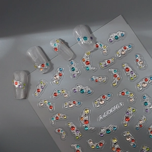 Exotic boho nail art stickers with silver embossed metal bases and multicolor rhinestones