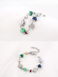 Detailed macro view of colorful beaded bracelet with daisy charm and metal dice pendant
