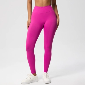 Close-up of seamless rose red yoga pants showing high waist compression and elastic fabric