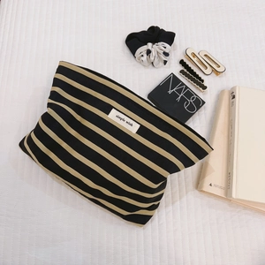 Striped cotton canvas makeup bag with Simple Wish label on a white textured background