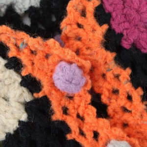 Gros plan sur le gilet en crochet coloré fait main avec texture ajourée complexe