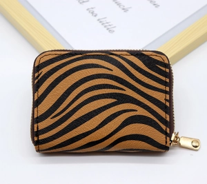 Detail of tiger print leather card holder featuring a gold zipper and grainy PU texture