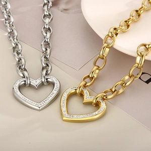 Set of gold and silver chunky chain necklaces with heart pendants and sparkling zircons