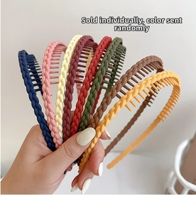 Close-up of matte plastic headbands with non-slip teeth in various random colors