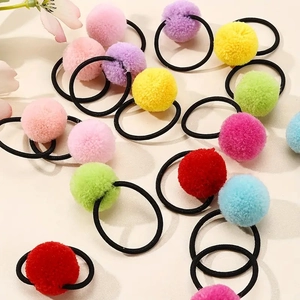 Detailed view of colorful plush pom pom hair ties with elastic bands in candy colors
